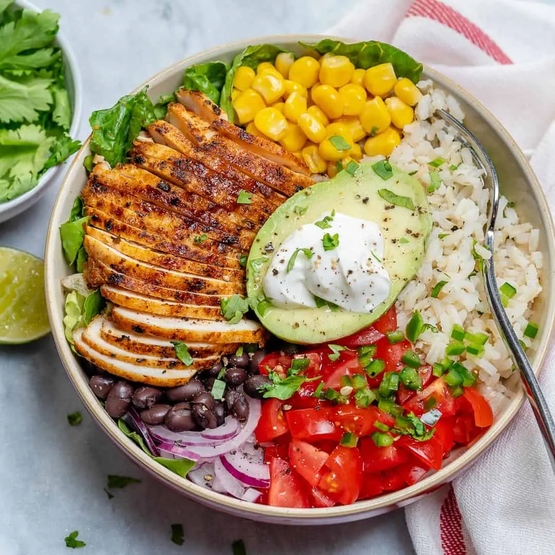 Chicken burrito bowl with rice, beans, and toppings